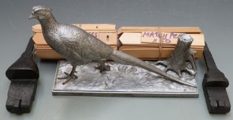 A silvered metal model of a pheasant on naturalistic base together with two cast shotgun lock