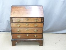 A 19thC oak bureau with leather inset tall flap, fitted interior and four graduated drawers raised