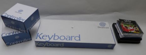 Three Dreamcast accessories comprising Keyboard and two Controllers, all in original boxes