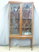 A late 19th/20thC inlaid mahogany astragal glazed display cabinet/bookcase on stand with dogtooth