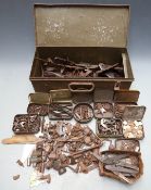 A large collection of gun parts including locks, hammers, springs, butt plates etc including some