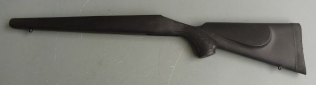 Three synthetic rifle stocks, one Remington with chequered semi-pistol grip and forend and raised