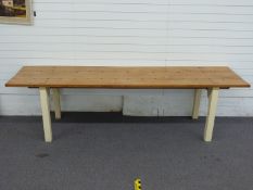 A 19th/20thC elm three plank dining table with inset riveted decoration raised on a painted oak