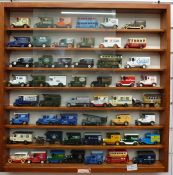 Ninety-four Lledo and similar diecast model vehicles in three wooden shelf displays together with