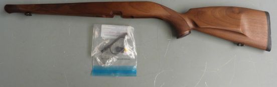 Wooden rifle stock with chequered semi-pistol grip, raised cheek piece, trigger guard and sling