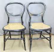 A pair of Victorian mother-of-pearl inlaid ebonised balloon back bergere chairs in the style of