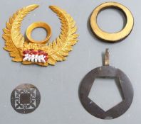 Four Japanese kabuto helmet maedate, largest 19cm in diameter.