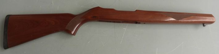 Three wooden rifle stocks, two with semi-pistol grips and padded butt plates.
