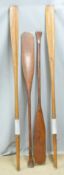 A pair of oars with leather sleeves, L 179cm and a pair of paddles