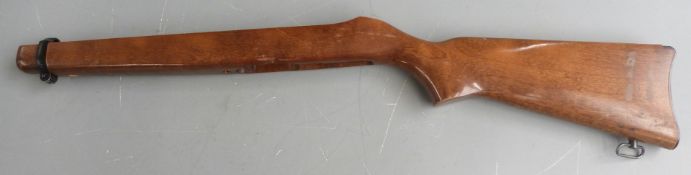 Four wooden rifle stocks, one with chequered semi-pistol grip and trigger guard, two with sling