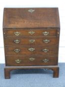 Georgian oak bureau with fitted interior with four graduated drawers raised on bracket feet, W76 x