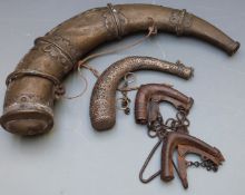 Four Eastern powder flasks, one large brass horn shaped example, one white metal and two smaller