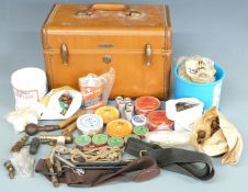 A collection of gun and shooting accessories including snap-caps, cleaning kit, oil, primers,
