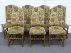 A set of seven upholstered oak dining chairs