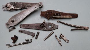 Four hammer action gun lock plates together with various parts and springs.
