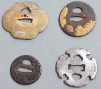 Four Japanese Samurai sword tsuba, some with pierced and gilt decoration, largest 8.5cm in diameter.