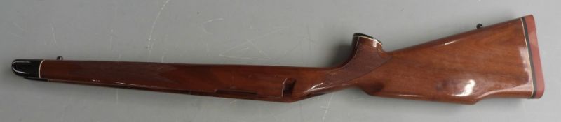 Three bolt action rifle stocks, all with chequered semi-pistol grips and inlaid forends.