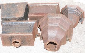 Four cast iron rainwater hoppers / planters, tallest 24cm