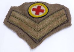 British Army WW1 era Royal Army Medical Corps insignia and corporal's chevrons cut from uniform