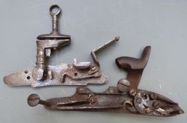 Two gun locks comprising one Spanish Miquelet flintlock with engraved decoration (13cm long) the
