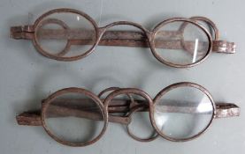 Two pairs of Georgian steel spectacles, one marked 100, width of larger when closed 11.5cm