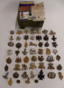 Small collection of military metal and cloth badges, rank insignia, buttons etc