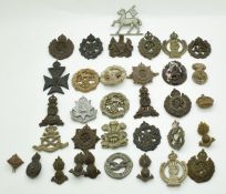 Approximately 30 WW2 plastic headdress badges including Queens, East Surrey, 4 RWF etc