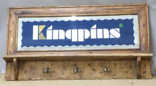 A pine mirror-backed advertising coat rack 'Kingpins', 63 x 18cm