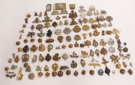 A collection of approximately 100 cap badges including Dorsetshire Regiment, North Irish Horse,