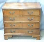 A reproduction mahogany bachelor's chest of two over three graduated drawers raised on bracket feet,