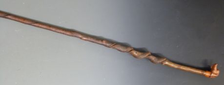 Carved wooden walking stick with pommel in the form of a dog's head and spiralling shaft, L130cm