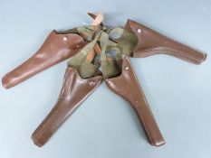 Four brown leather and canvas pistol or revolver holsters, each 28x13cm.