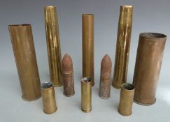 Eight brass shell casings including British six pounder dated 1916 and a German 1917 example,