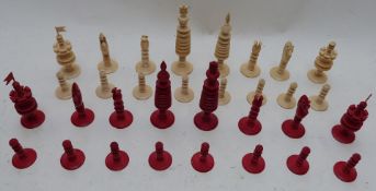 A 19thC turned ivory chess set with one side stained red, height of king 13cm.