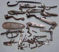 Three sets of hammer action shotgun parts including pairs of locks, springs, hammers, butt plates