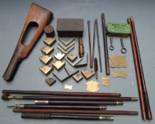 A collection of gun parts and accessories including nipple keys, cleaning rods, a folding metal
