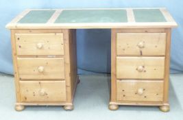 A pine leather inset twin pedestal desk, W136 x D70 x H77cm
