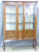 Edwardian inlaid mahogany glazed display cabinet with bow fronted decoration, raised on cabriole