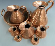 A set of seven 19thC copper measuring jugs from ½ gill to one Imperial gallon and a twin handled jam