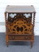 A 19th/20thC rosewood Canterbury with single drawer raised on turned legs and castors, W53 x D48 x