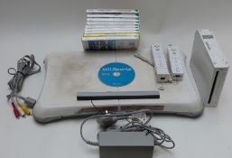 Nintendo Wii video games console together with a Wii Fit board and eight games.