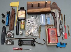 A collection of gun parts, accessories and tools including over and under pistol barrels, air