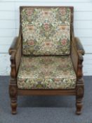 A 19th/20thC bergere upholstered armchair with leather armrest and Liberty style fabric, W70 x D85 x