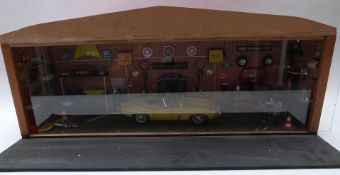 A scratch built 1:18 scale workshop or garage diorama fitted with electric lights featuring an e-