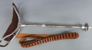 A vintage shooting stick together with a brown leather 12 bore shotgun cartridge belt and a wooden