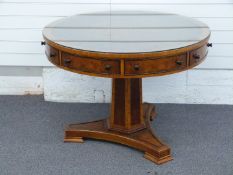 A contemporary Amboyna veneer library drum table with crossbanded mahogany and ebonised cockspur