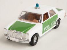 Corgi Toys diecast model Mercedes-Benz 240D police car with white and green body and tan interior,
