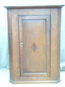 A 19thC inlaid oak hanging corner cupboard, W66 x H98cm