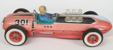 Masudaya Japan tinplate battery operated model racing car with red body, blue driver, red and