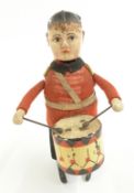 Schuco clockwork tinplate British Soldier Guardsman Drummer with red felt jacket and black felt